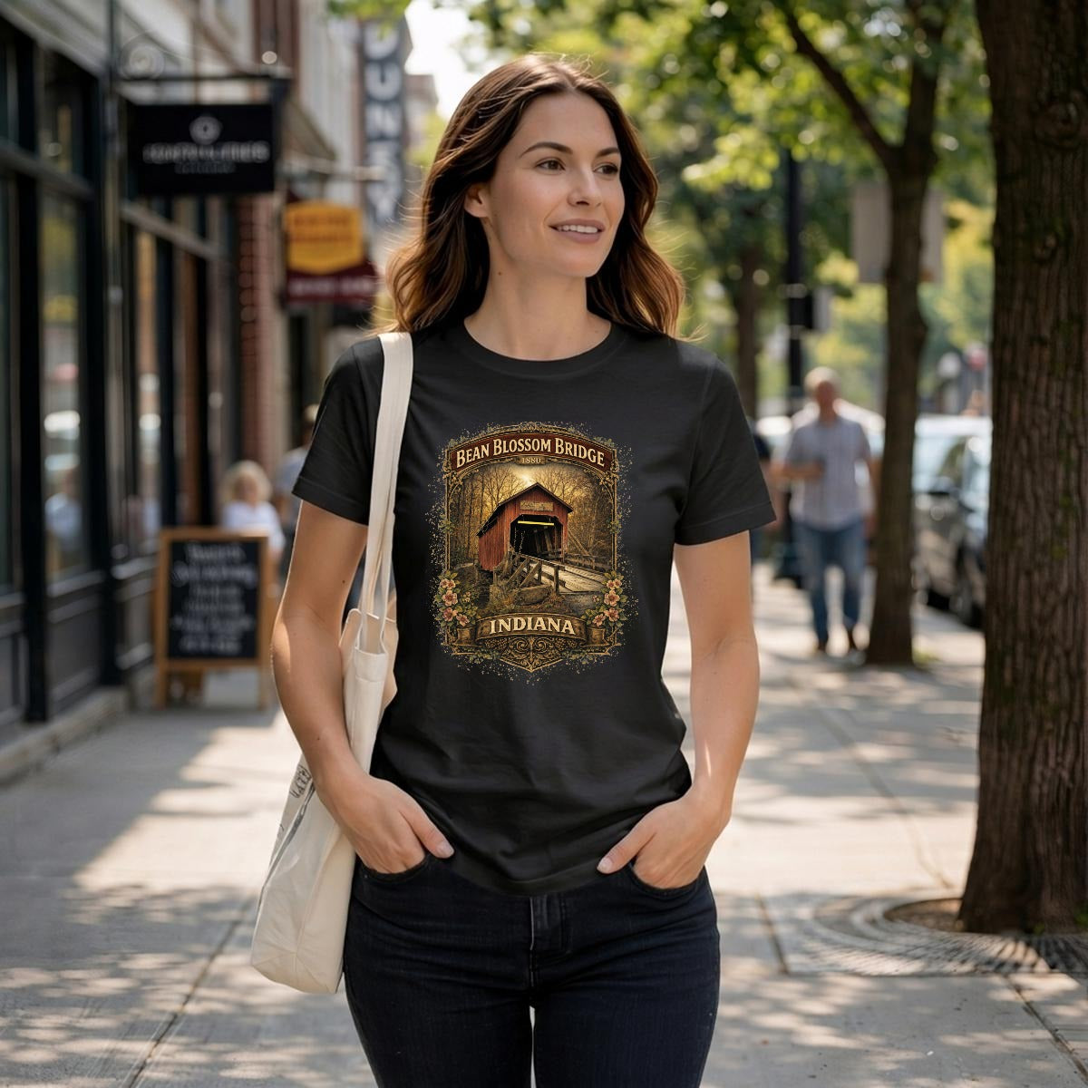 Women wearing a black t-shirt of a vintage graphic bean blossom bridge shirt.