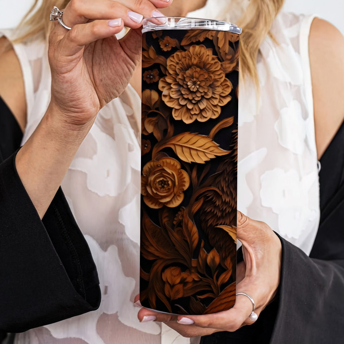 Person holding a 20 oz straight tumbler with 3D tooled leather bear design.