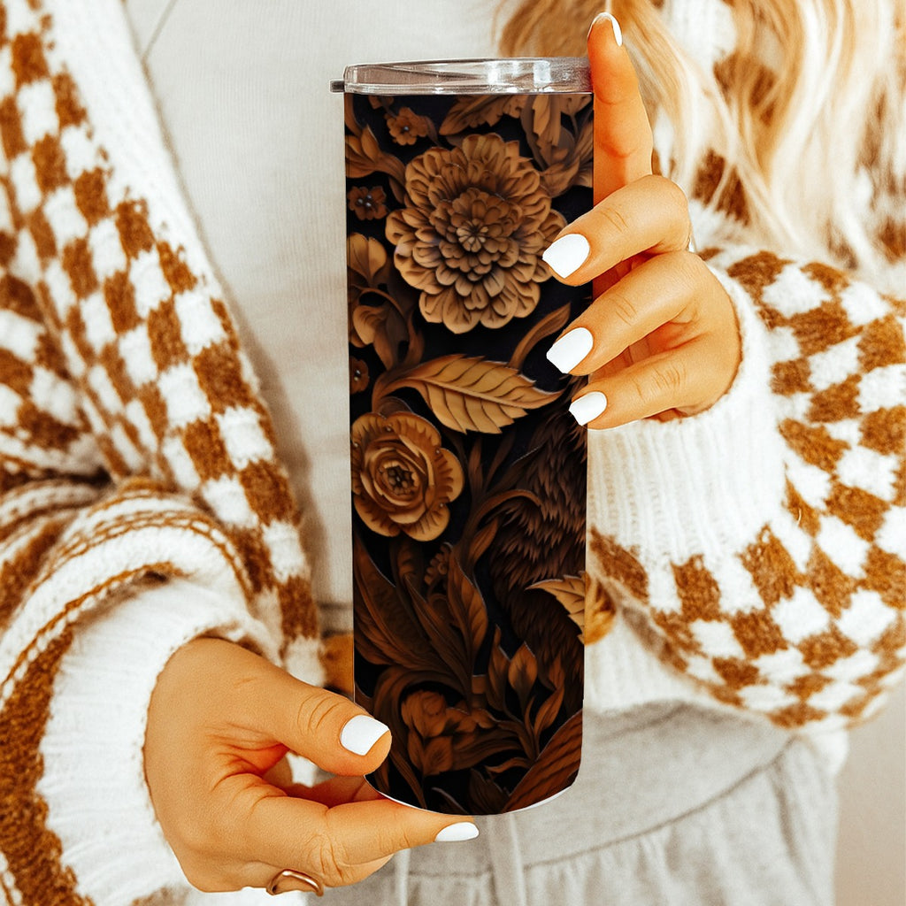 Woman holding 20 oz straight tumbler with 3D tooled leather bear design. 