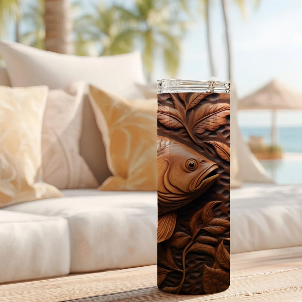 20 oz straight tumbler with 3D tooled leather brown-fish design on a table outdoors.
