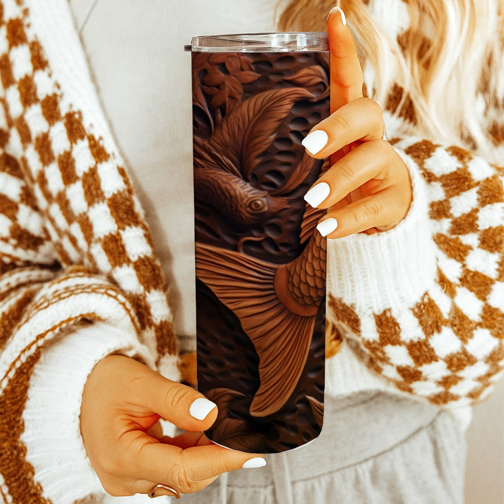 Woman holding 20 oz straight tumbler with 3D tooled leather brown-fish design. 