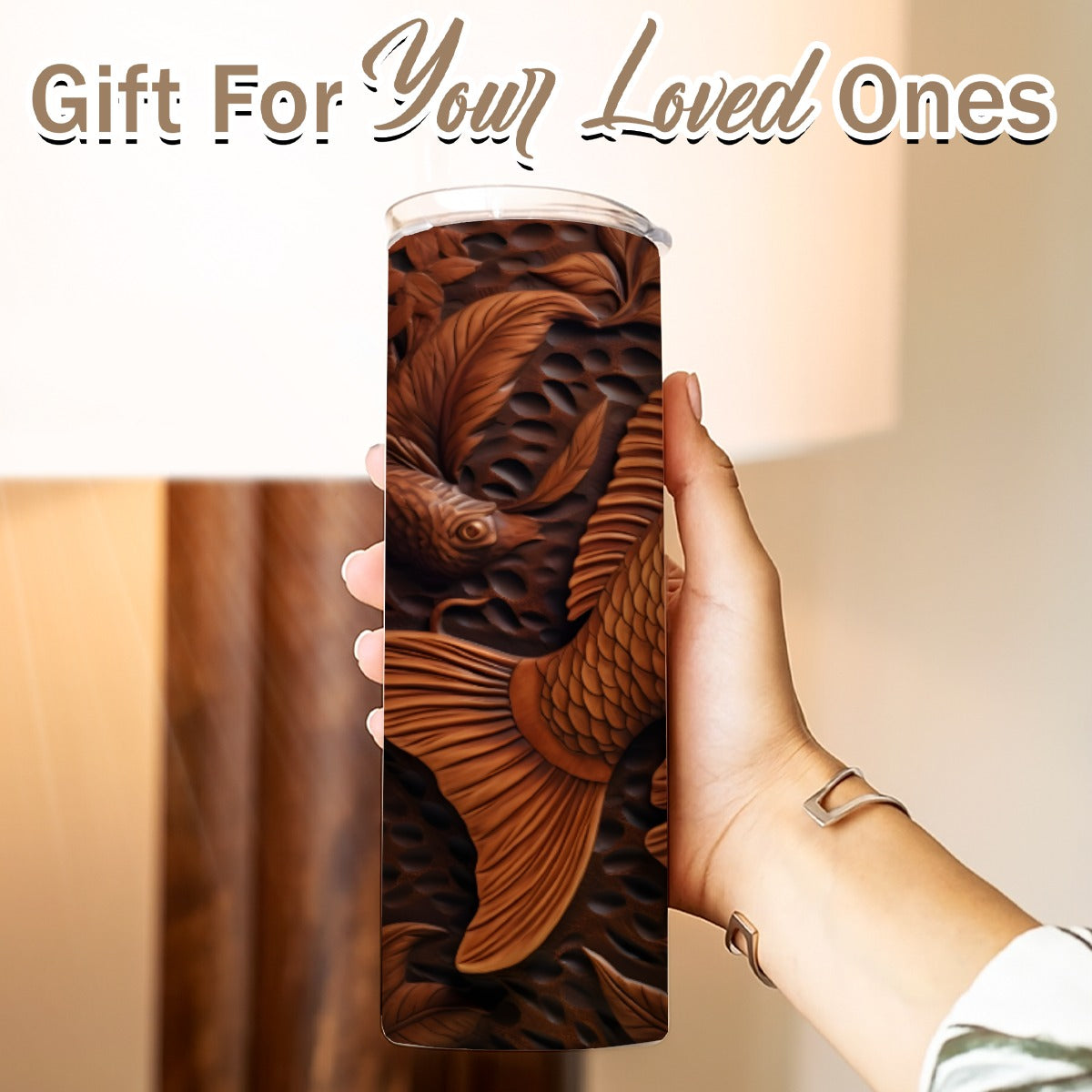 Hand holding a 20 oz straight tumbler- tooled leather brown-fish design
Gift For Your Loved Ones on a blurred background.