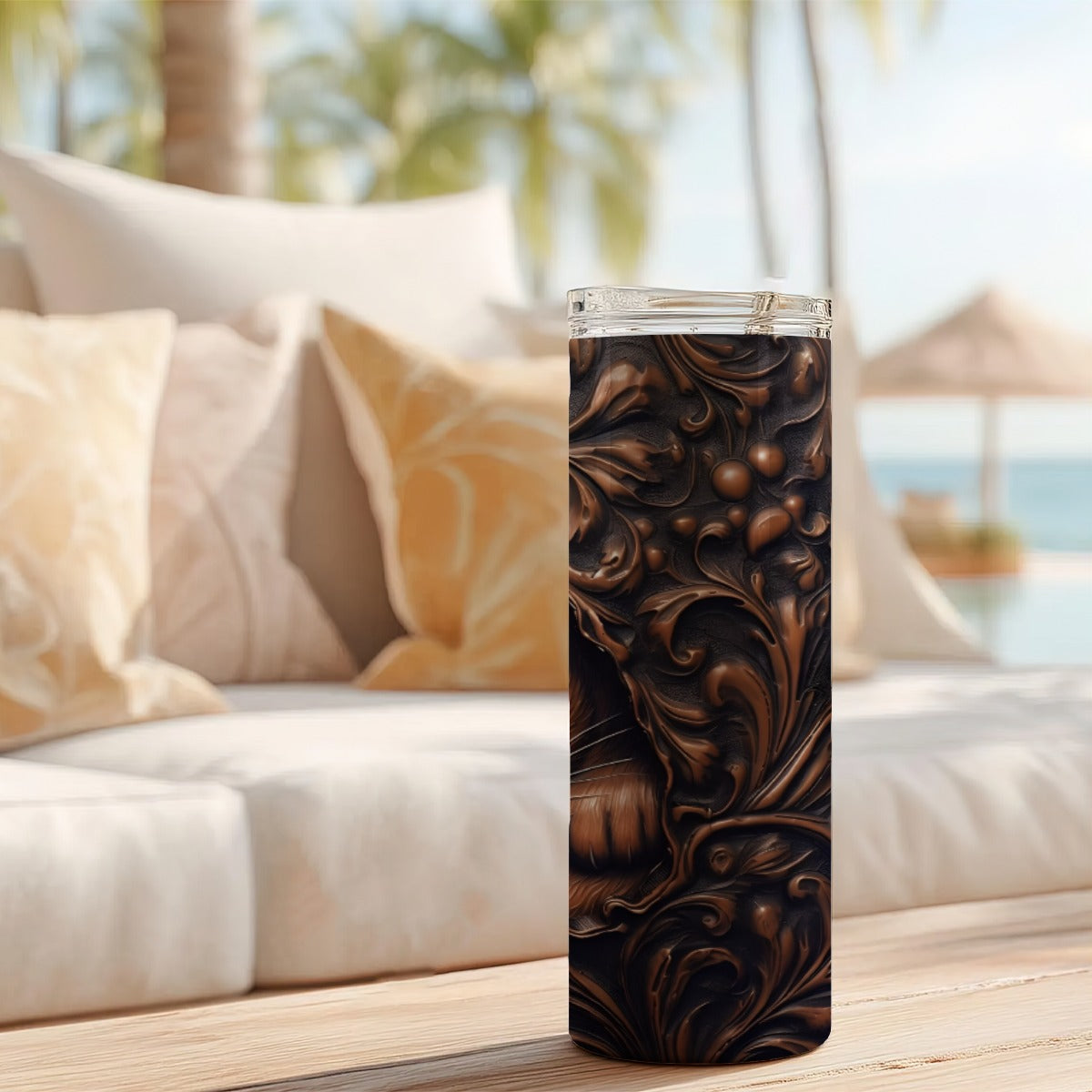 20 oz straight tumbler with 3D tooled leather cat design on a table outdoors.