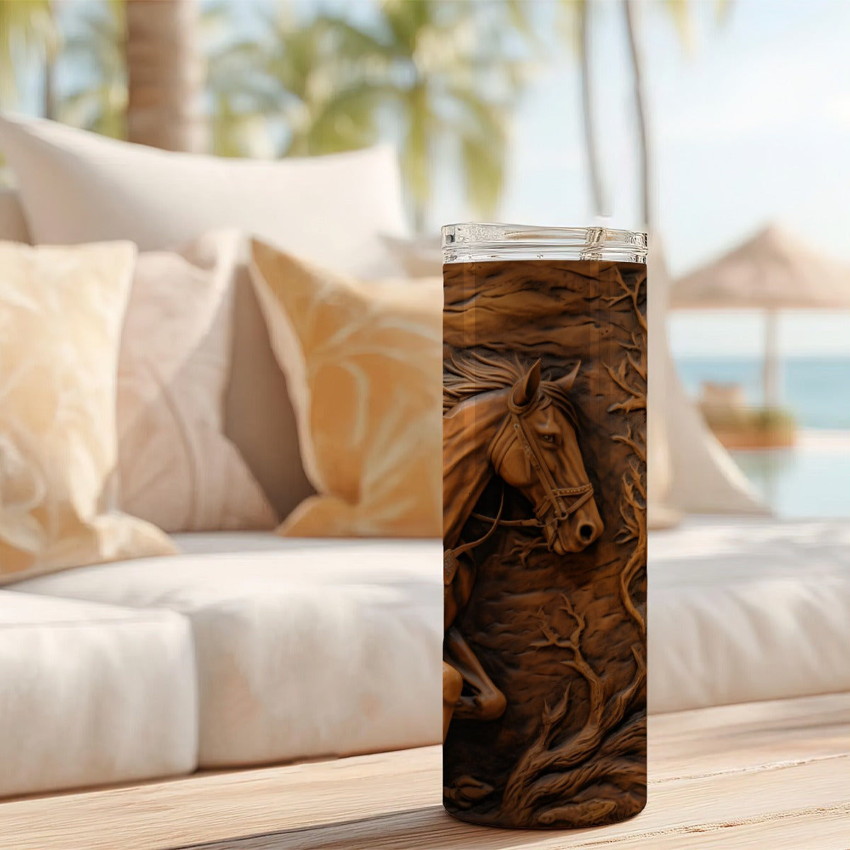 20 oz straight tumbler with 3D tooled leather cowboy design on a table outdoors.