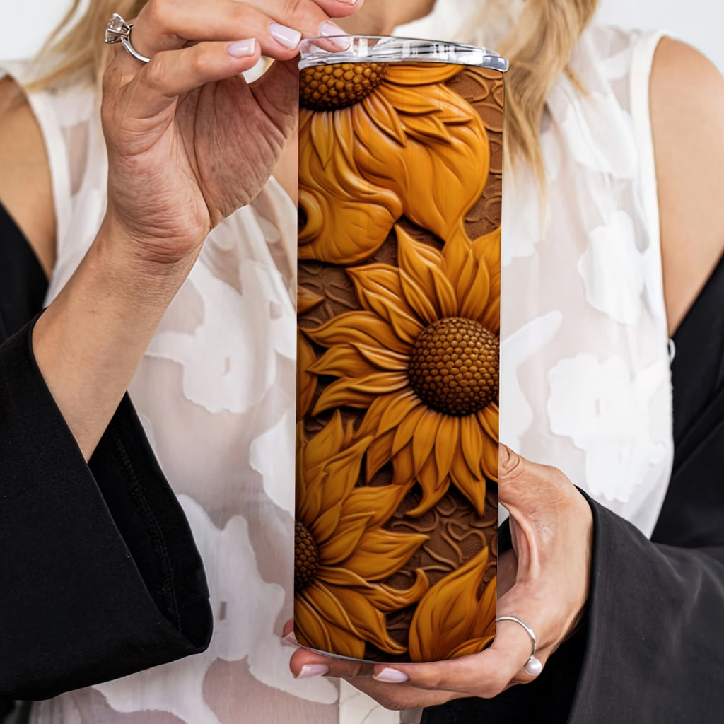 Person holding a 20 oz straight tumbler with 3D tooled leather dark-sunflower design.