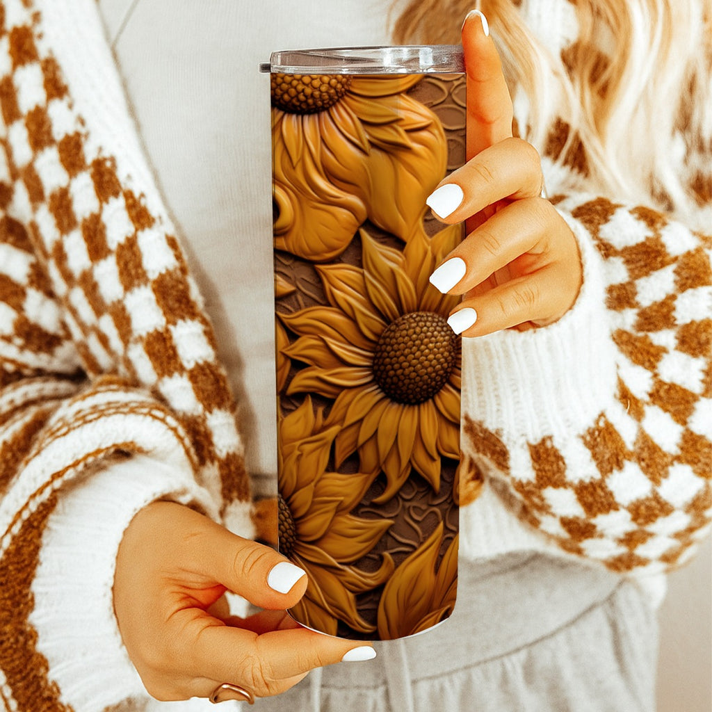 Woman holding 20 oz straight tumbler with 3D tooled leather dark-sunflower design. 