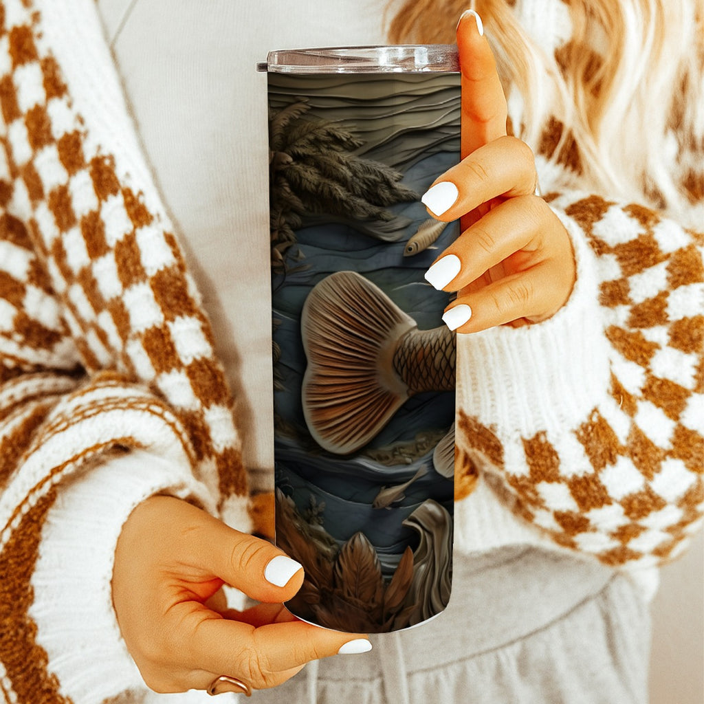 Woman holding 20 oz straight tumbler with 3D tooled leather fish design. 