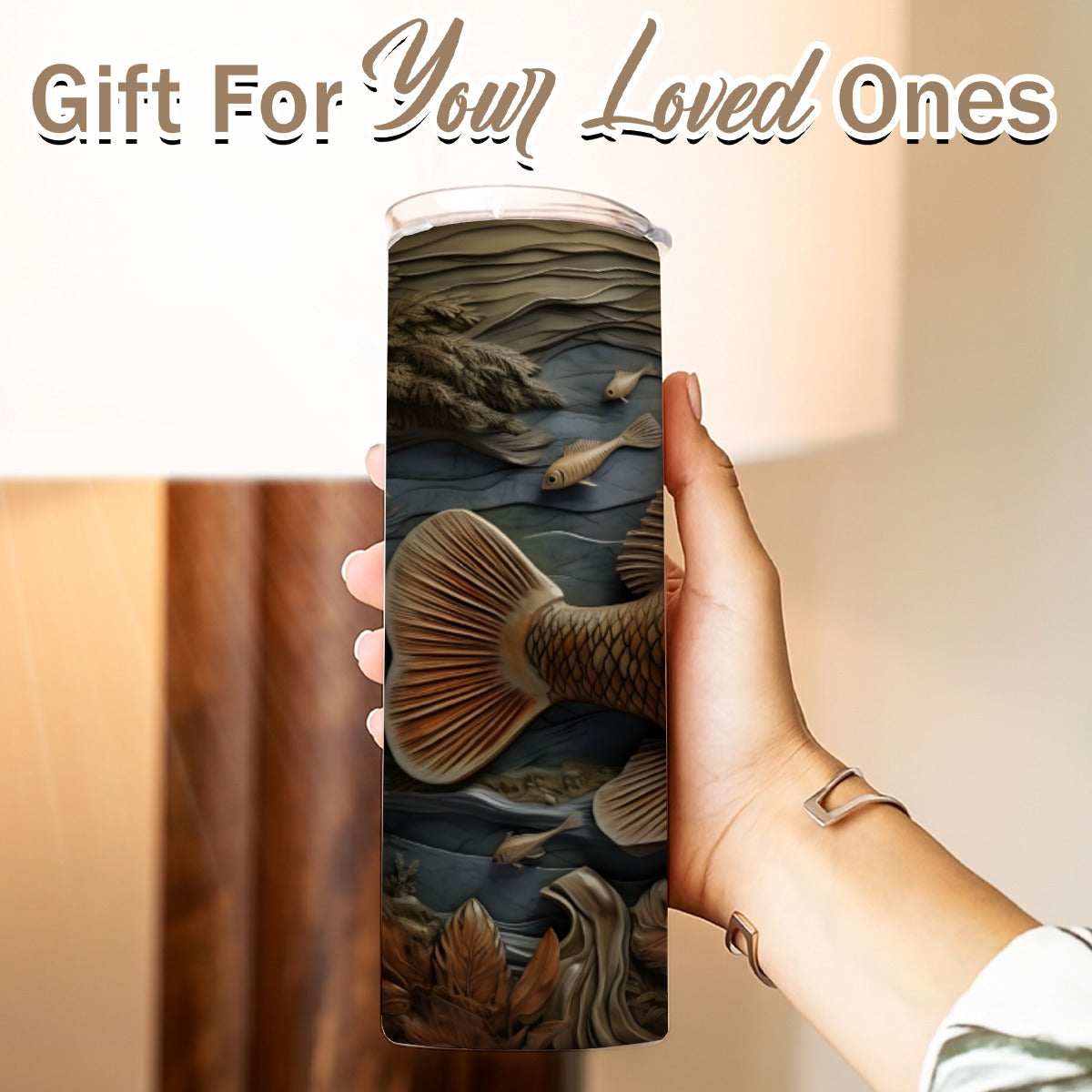 Hand holding a 20 oz straight tumbler- tooled leather fish design
Gift For Your Loved Ones on a blurred background.