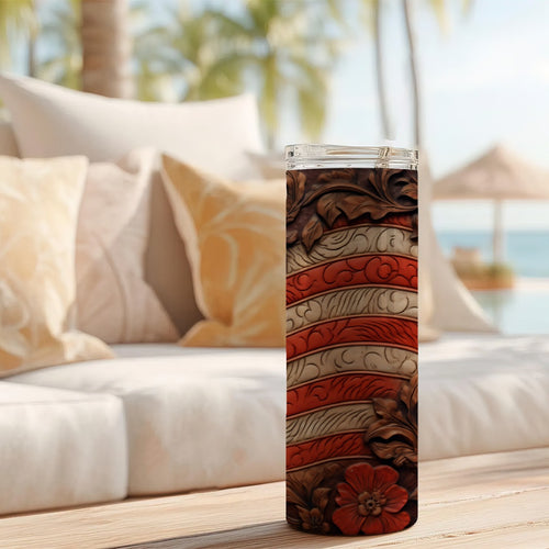 20 oz straight tumbler with 3D tooled leather flag design on a table outdoors.