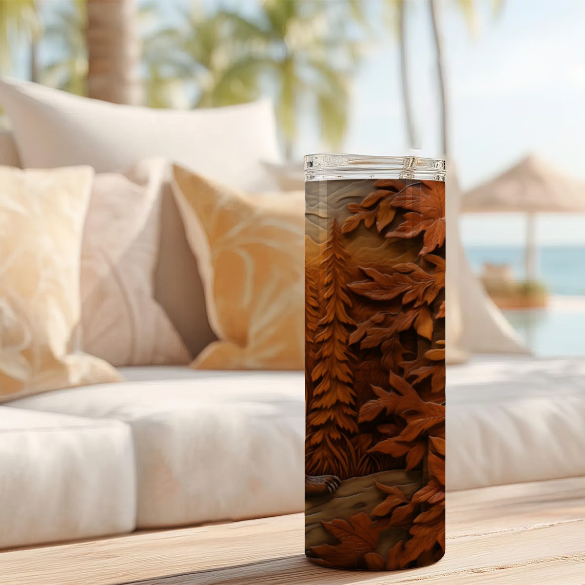 20 oz straight tumbler with 3D tooled leather grizzly bear design on a table outdoors.