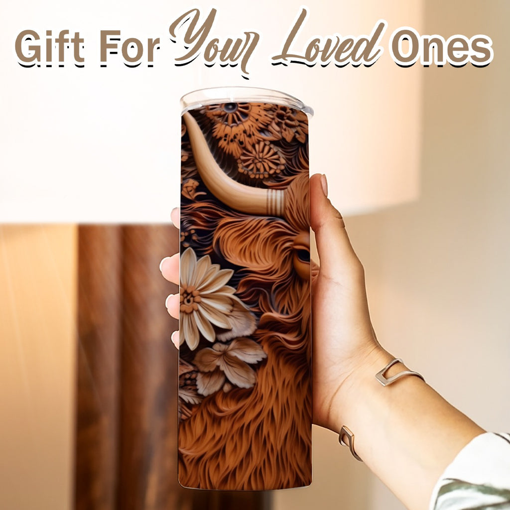 Hand holding a 20 oz straight tumbler with 3D tooled leather highlander cow design Gift for Your Loved Ones on a blurred background.