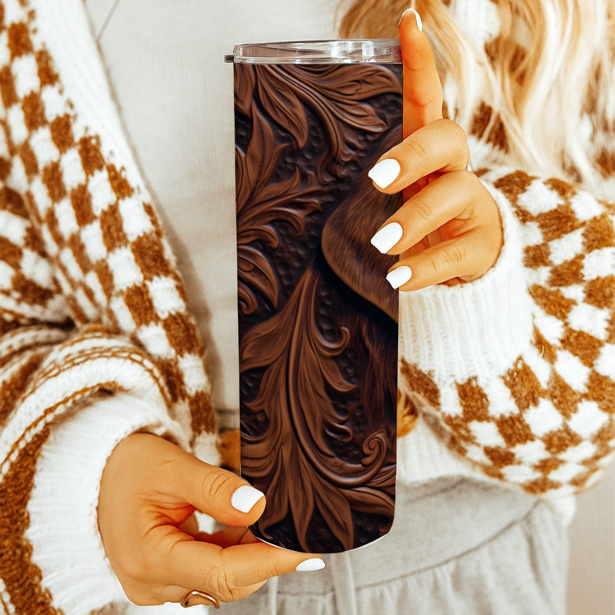 Person holding a20 oz straight tumbler with 3D tooled leather hunting dog design with a cozy indoor background.