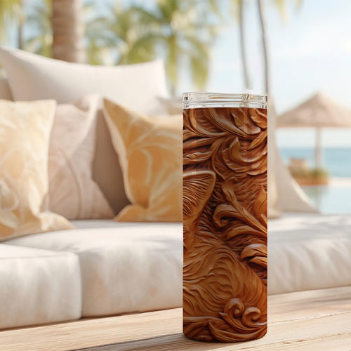 20 oz straight tumbler with 3D tooled leather kitten design on a table outdoors.