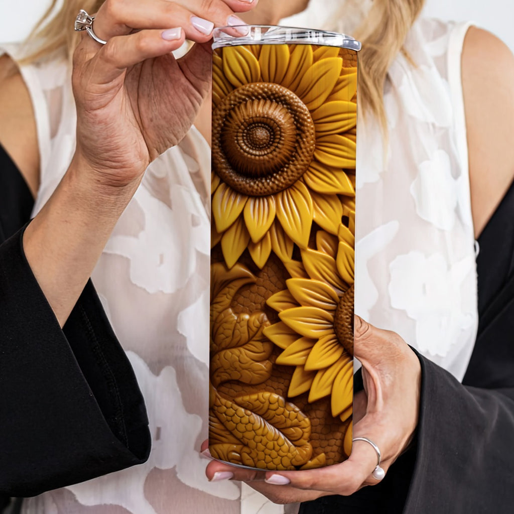 Woman holding 20 oz straight tumbler with 3D tooled leather sunflower design. 
