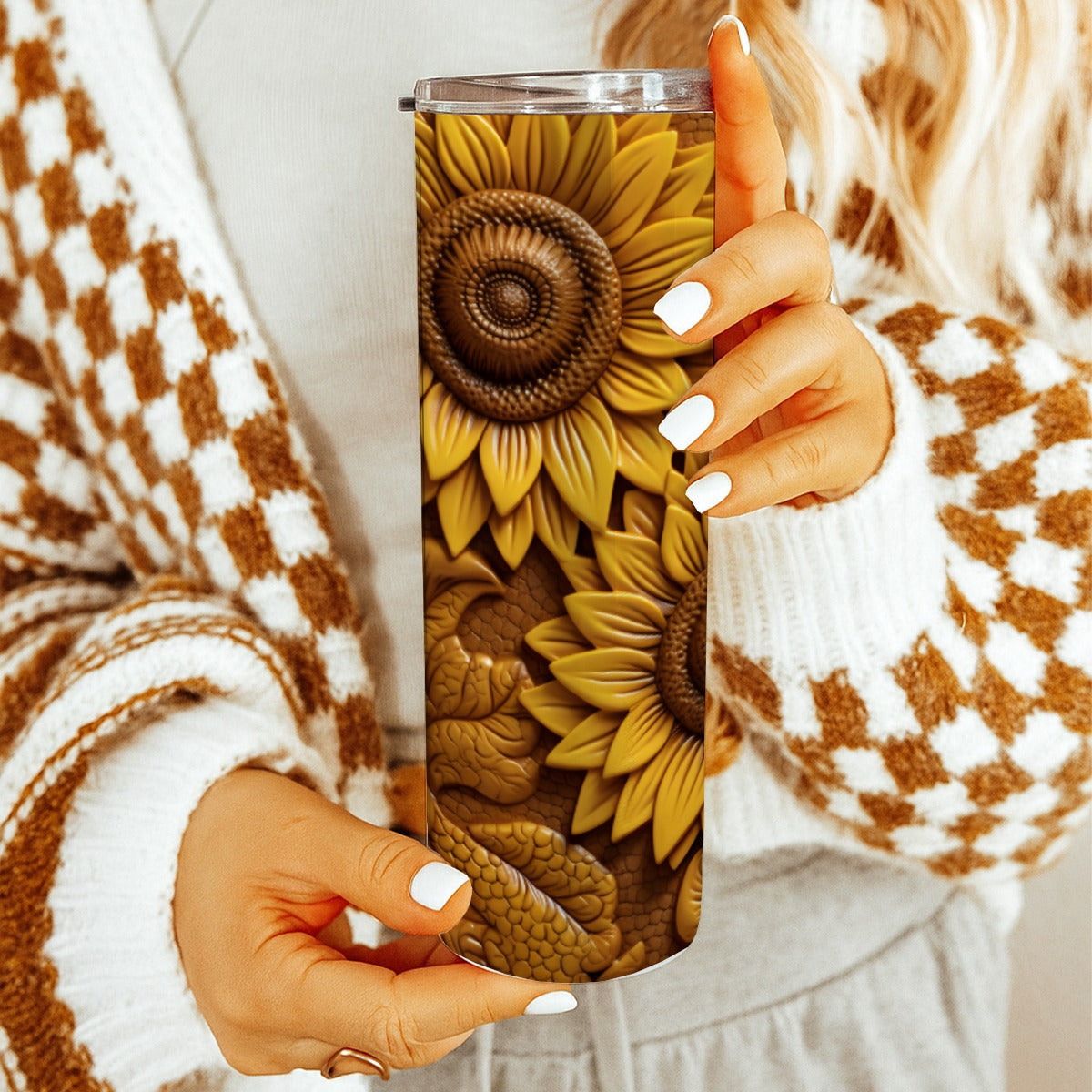 Person holding a 20 oz straight tumbler with 3D tooled leather sunflower design.