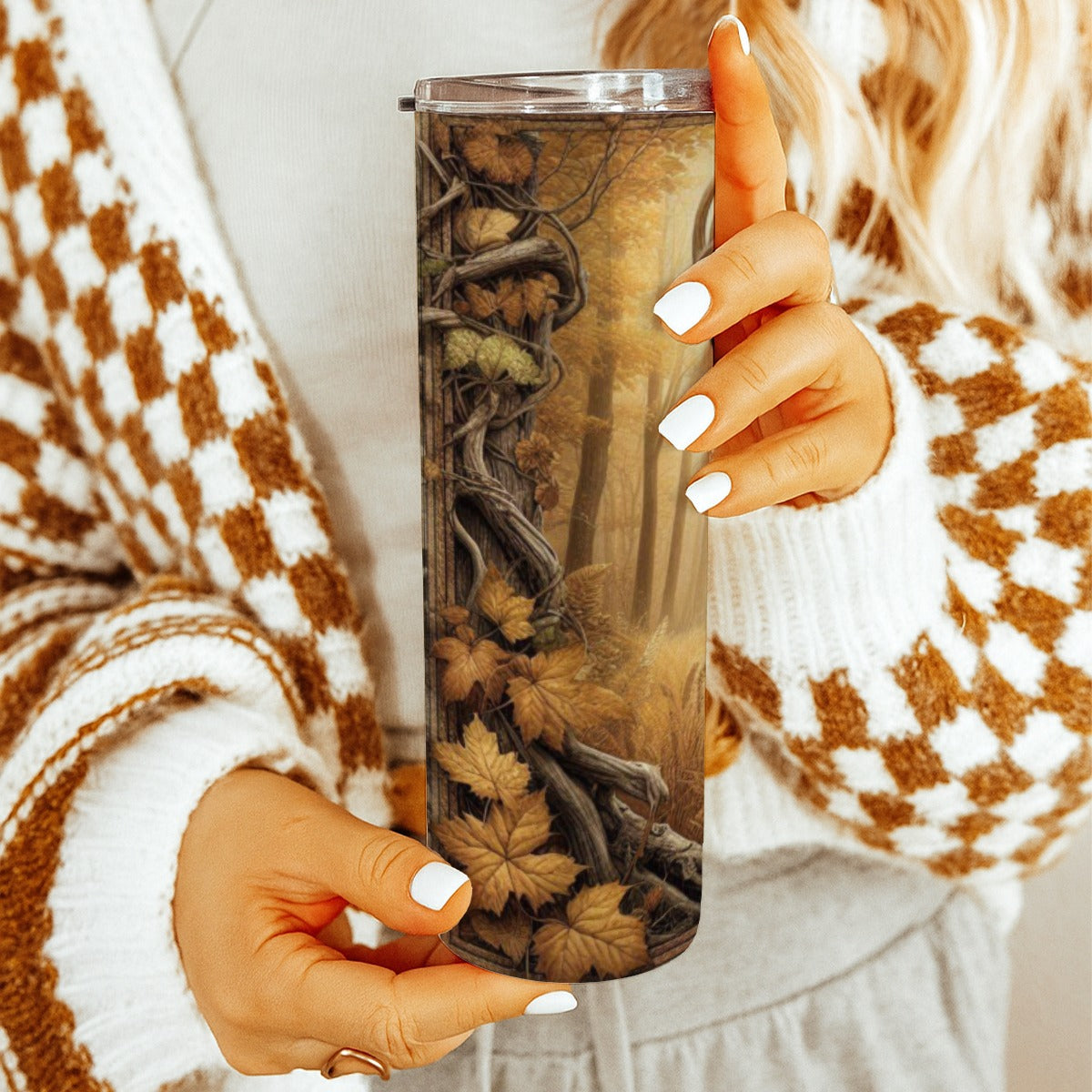 Hand holding a 20 oz straight tumbler with 3D tooled leather Whitetail deer design.