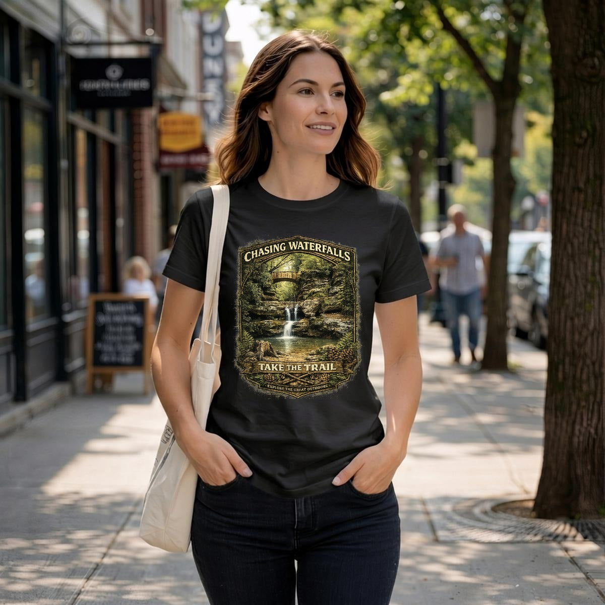 Women wearing a black t-shirt of a vintage graphic design-Chasing Waterfalls Upper Old Man's Cave Shirt.