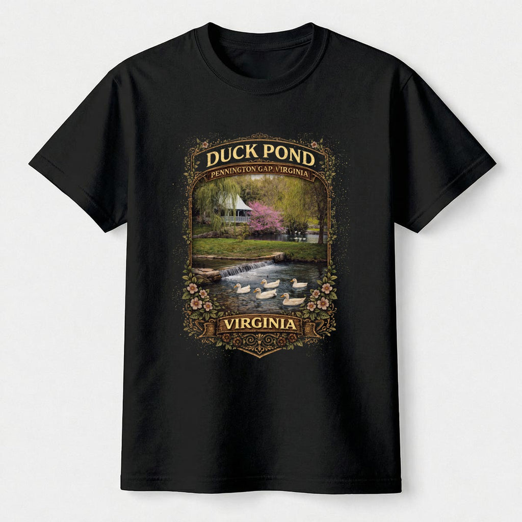 Black t-shirt with a graphic of a duck pond and watermill on a white background.