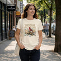 Woman wearing a natural-colored tee with an-Expensive Taste in Birds-graphic featuring red cardinal-botanical elements.