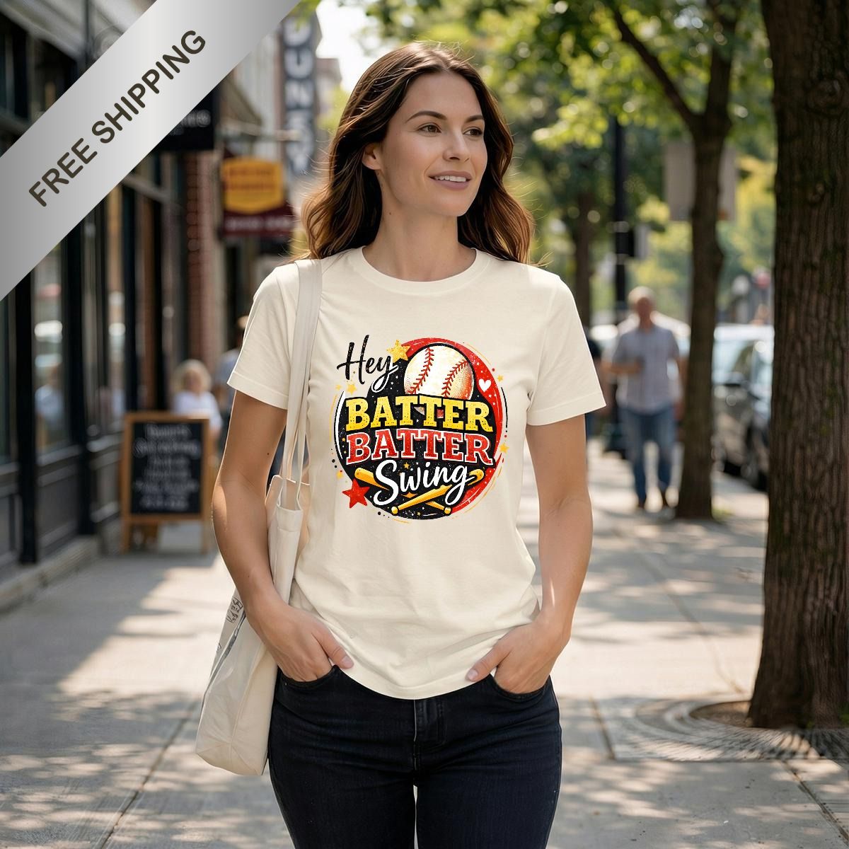 Woman sitting on a couch wearing a white t-shirt with a colorful graphic design.