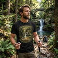 Man wearing a black t-shirt with graphic design - Chasing Waterfalls Upper Old Man's Cave Shirt, in a nature park.