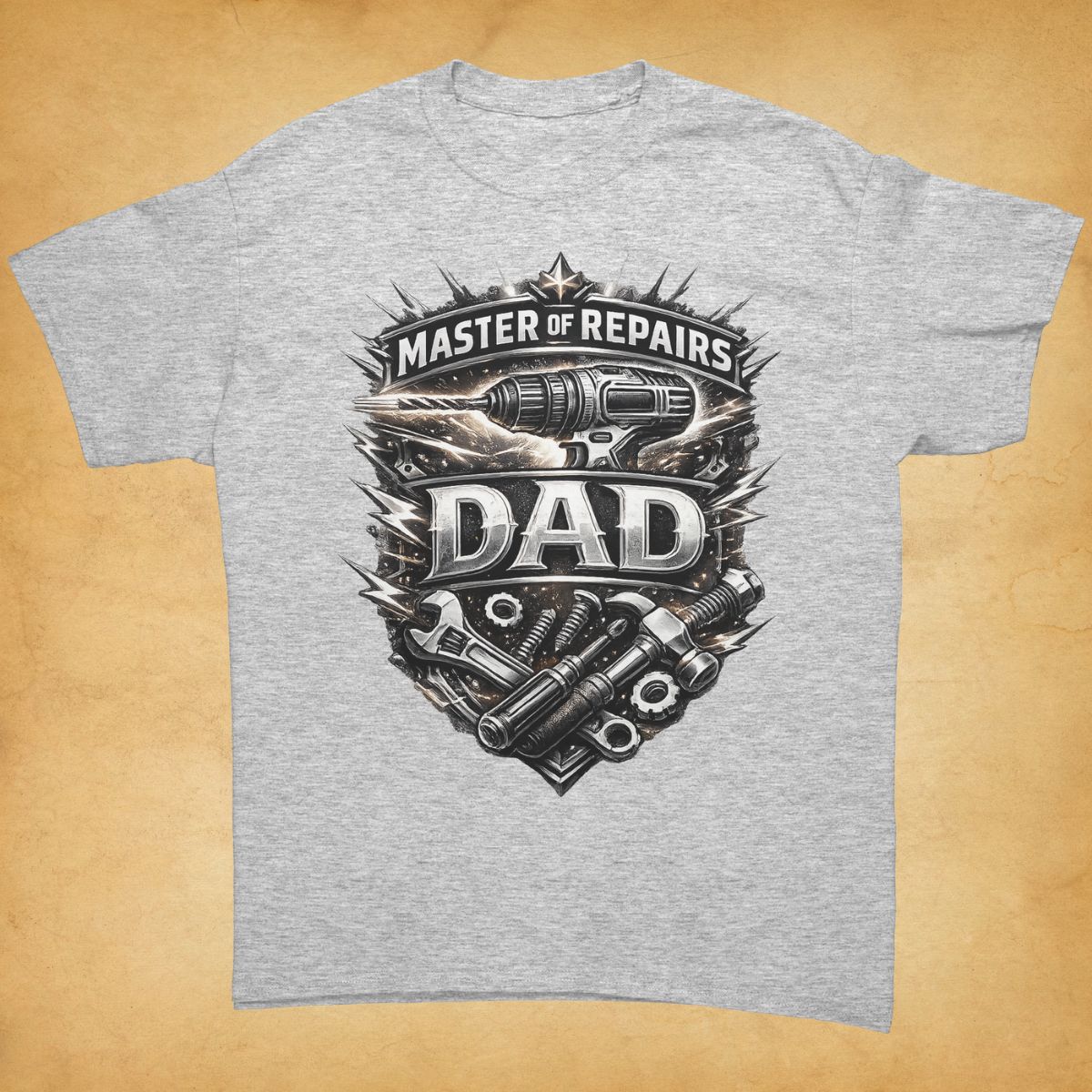 Gray t-shirt with Master of Repairs Dad graphic design on a beige background.