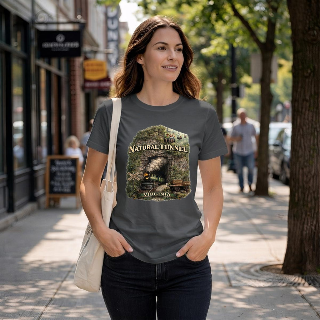 A woman walks down a street wearing a dark grey graphic t-shirt featuring a steam train coming out of a tunnel.