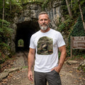 Close-up of a man by a tunnel wearing a vintage shirt showing a steam train emerging from the tunnel.