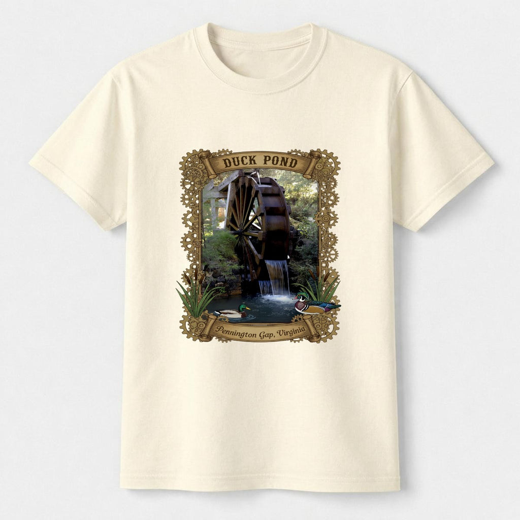 Cream-colored t-shirt with a graphic of a duck pond and watermill on a white background