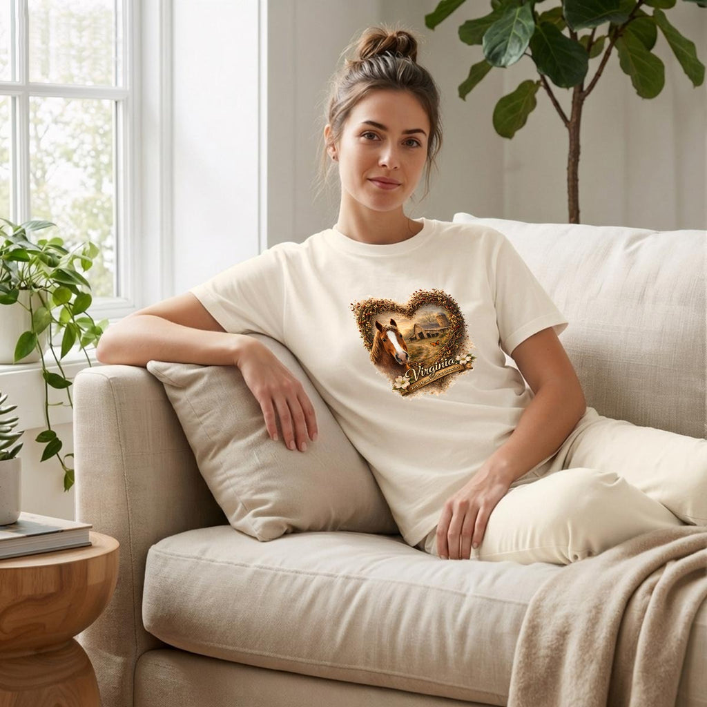 Woman wearing a Virginia heartland horse and barn graphic tee with a heart collage of two photos.