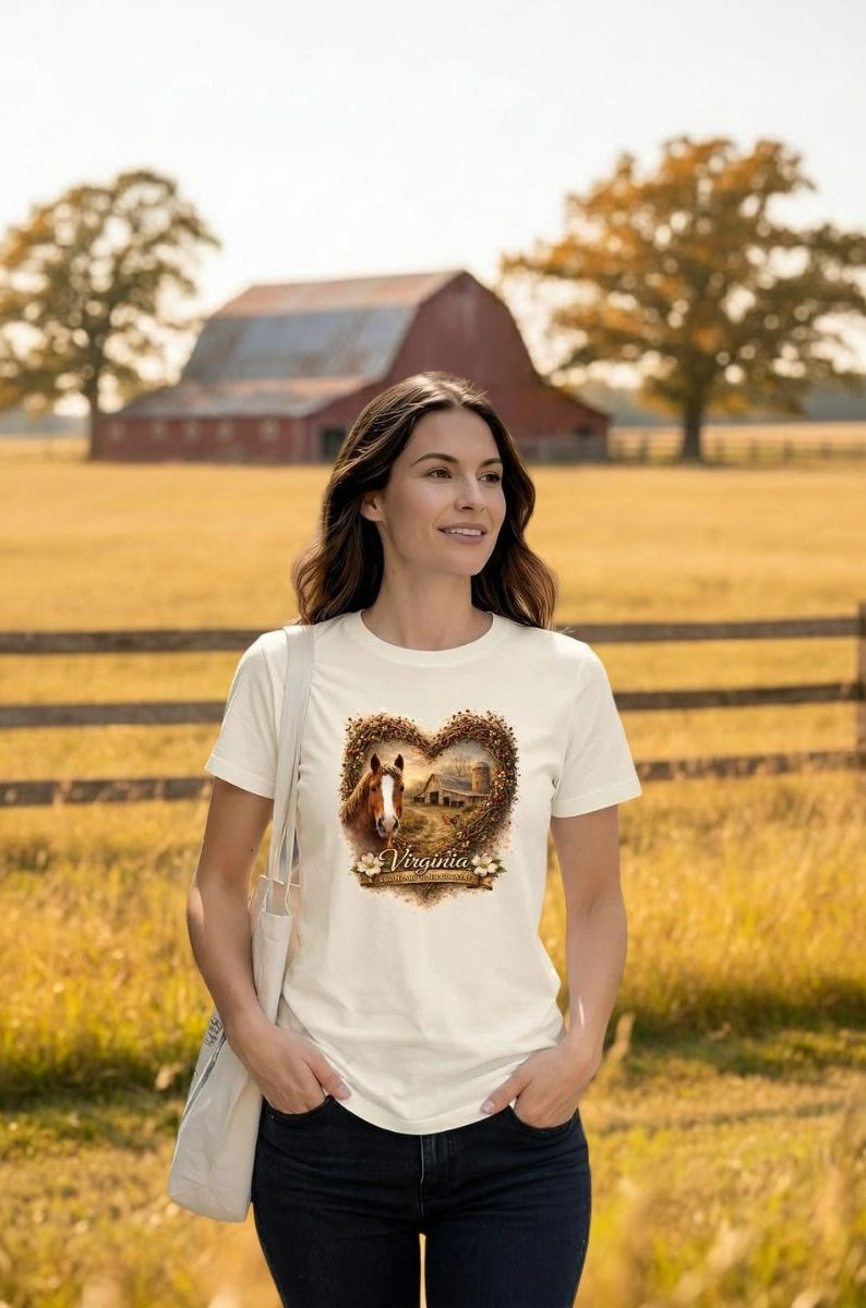 Woman wearing a Virginia Heartland Horse & Barn Graphic Tee with a heart-shaped collage of photos of a horse and a barn.