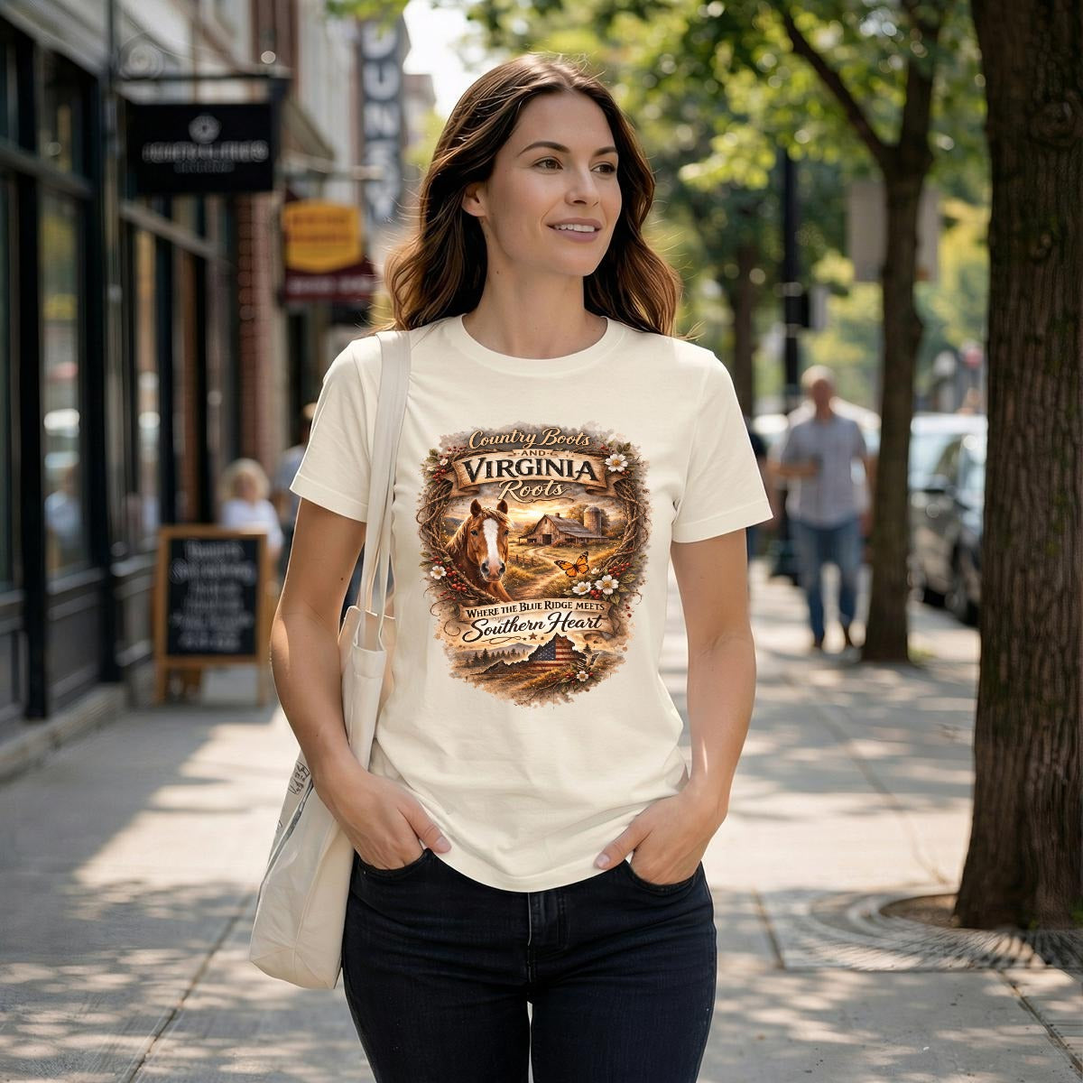 Woman wearing a natural-colored t-shirt with Virginia Roots graphic design on a city street.