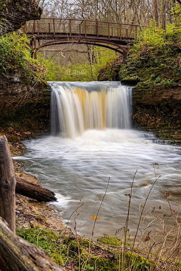 Waterfall flowing under a wooden bridge-located in Yellow Springs, Ohio.